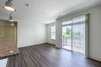 A spacious room with a marble countertop and wooden flooring.